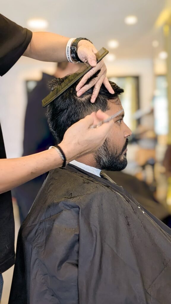 Professional hair stylist consulting a client on haircut style at a premium salon and spa in Bangalore